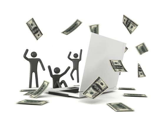 Three figures celebrating around a laptop with money in the air